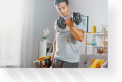 Man doing bicep curls with dumbbells at home