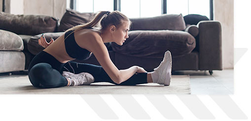 Young female stretching in living room