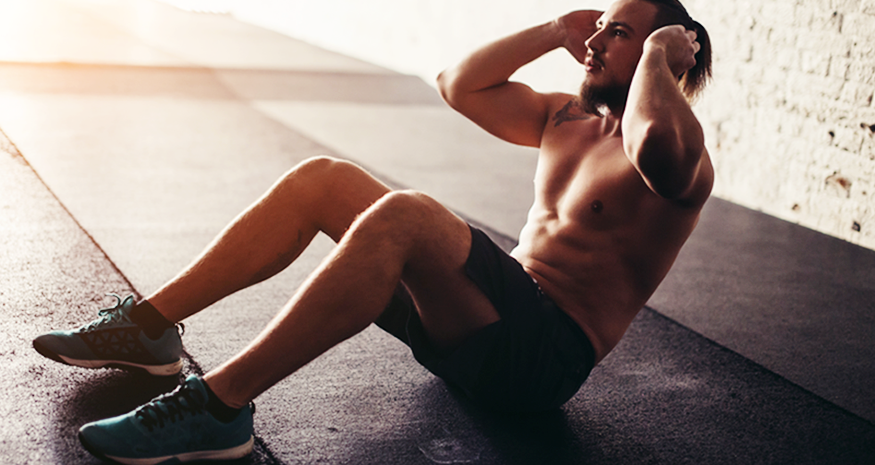 Man doing situps on gym floor