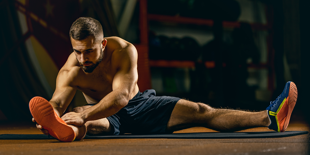 Shirtless guy stretching his arms and legs