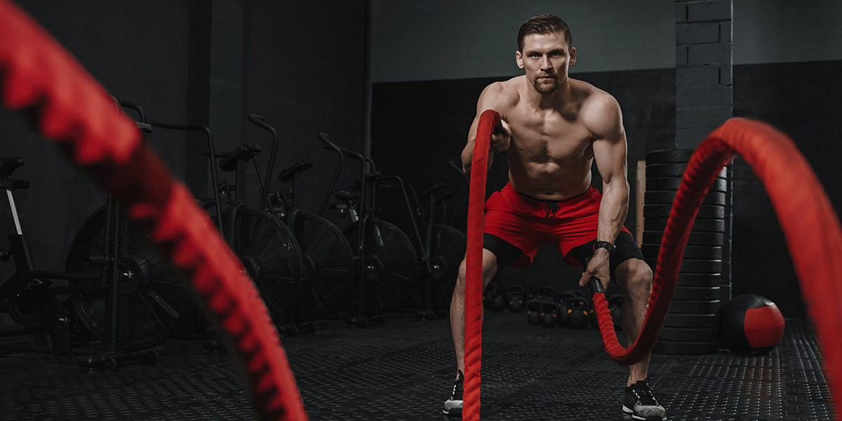 Guy doing a rope workout shirtless